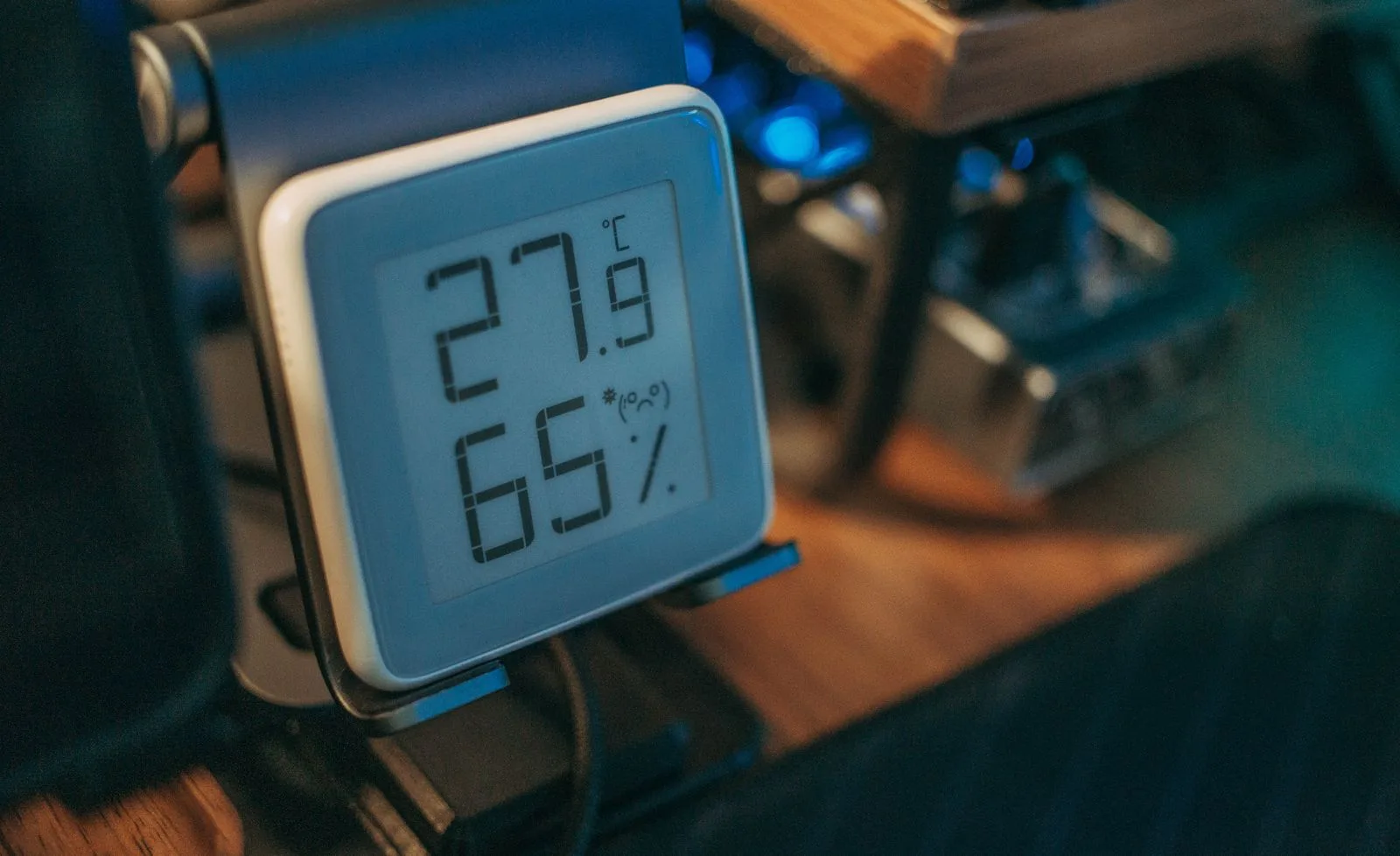 Digital hygrometer showing 65% relative humidity, a reading high enough to cause condensation on a cool basement wall